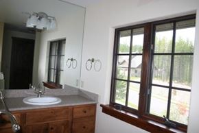 Whitefish apartment for rent - A bathroom with a sink, mirror, and a window.