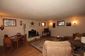 Whitefish apartment for rent - A living room with a fireplace and a television.
