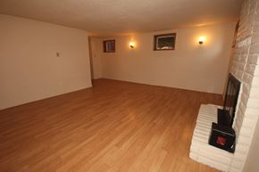 Whitefish apartment for rent - A room with wooden flooring and two wall-mounted lights.