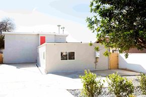 Imperial Beach apartment for rent - A white house with a red door and a brown fence.