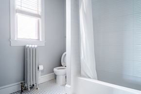 Washington apartment for rent - a bathroom with a toilet and a radiator and a window
