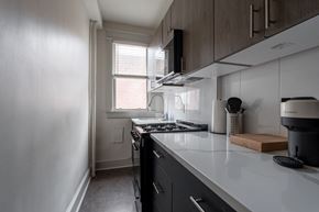 Washington apartment for rent - a kitchen with a counter top and a stove and a window