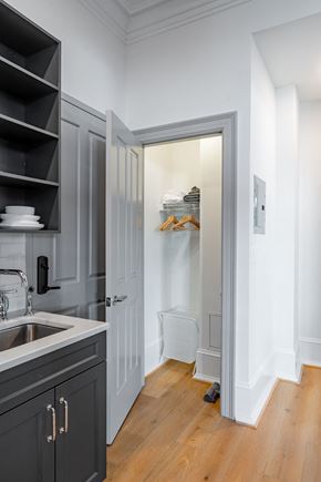 Washington apartment for rent - a small kitchen with a sink and a door to a closet