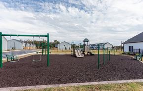 Fayetteville house for rent - A playground with a swing set and a slide.