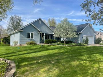 Menomonie house for rent - a blue house with a lawn in front of it