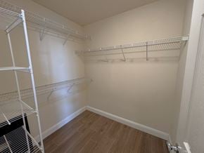 Merced house for rent - a spacious walk in closet with shelves and a wood floor