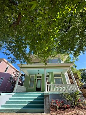 Little Rock apartment for rent - a green house with stairs and a tree in front of it