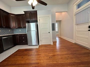 Little Rock apartment for rent - a kitchen with wood floors and a stainless steel refrigerator