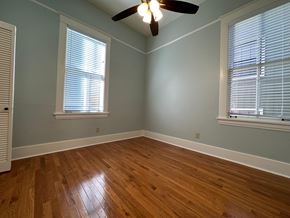 Little Rock apartment for rent - an empty bedroom with wood floors and a ceiling fan