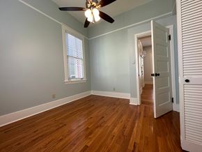 Little Rock apartment for rent - the living room of a house with wood floors and a ceiling fan