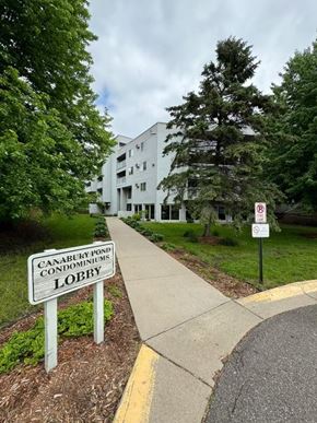 Little Canada house for rent - a sign on the side of a sidewalk in front of a building
