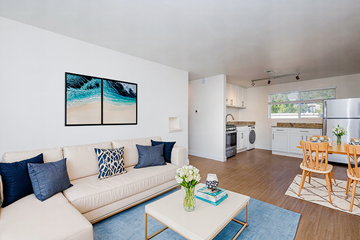 Denver apartment for rent - A living room with a white couch and a painting on the wall.