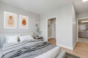 Denver apartment for rent - a bedroom with a bed and two paintings on the wall
