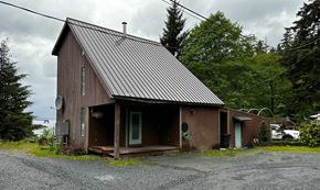 Sitka house for rent - a small brown house with a metal roof