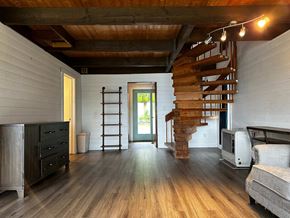 Sitka house for rent - a spiral staircase leads up to a loft in a tiny house
