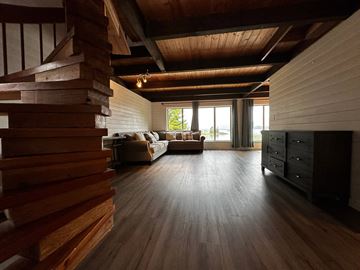Sitka house for rent - a living room with a couch and a wooden floor