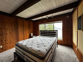 Sitka house for rent - a bedroom with a bed and a window