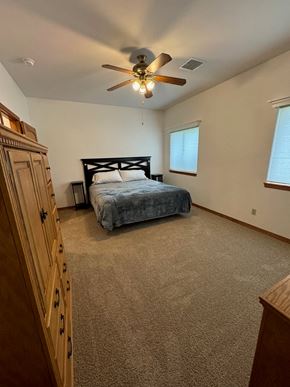 Pagosa Springs house for rent - a bedroom with a bed and a ceiling fan