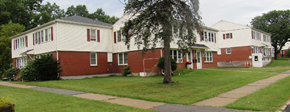 Massena apartment for rent - a row of houses on a street with a tree in the front