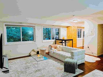 Alexandria apartment for rent - A living room with a white couch and a television.