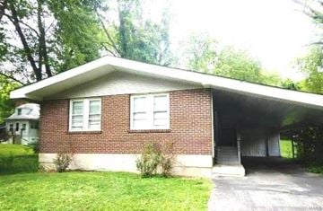 Ferguson house for rent - the front of a brick house with a garage
