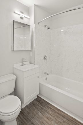 Louisville apartment for rent - A white bathroom with a toilet, sink, and bathtub.