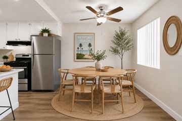 Anaheim apartment for rent - A kitchen with a table and chairs and a fridge.