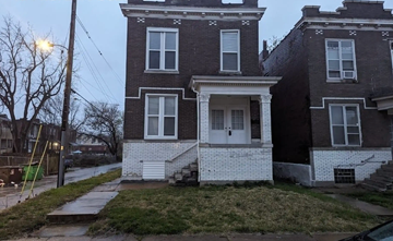 St Louis house for rent - the front of a brick house with a white door and stairs