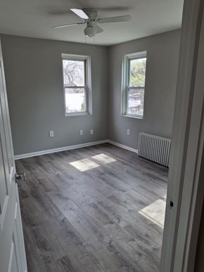 Collingswood apartment for rent - A room with a ceiling fan and two windows.