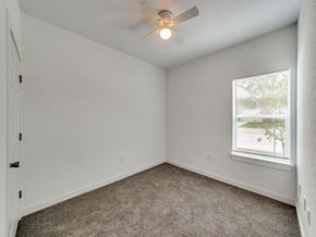 San Antonio apartment for rent - an empty bedroom with a ceiling fan and a window