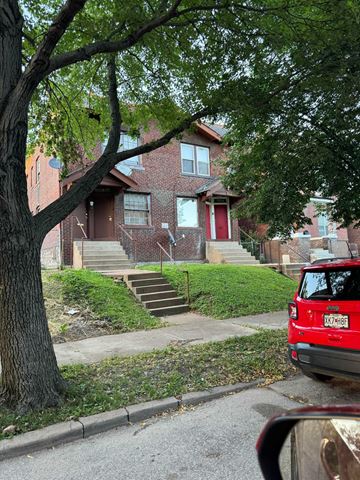 Saint Louis apartment for rent - a red car parked in front of a brick house