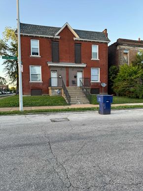 Saint Louis house for rent - an old brick house with a blue mailbox on the street