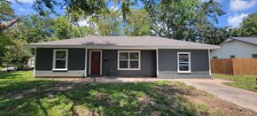 Sweeny house for rent - a small gray house with a yard and a driveway