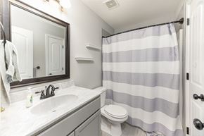 Clarksville house for rent - a bathroom with a shower and a sink and a toilet