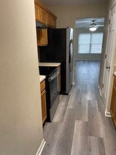 Cartersville house for rent - A kitchen with black appliances and wooden cabinets.