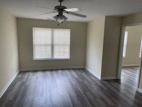 Cartersville house for rent - an empty living room with a ceiling fan