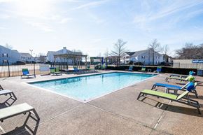 Robinsonville apartment for rent - A sunny day at the pool with lounge chairs and a picnic table.