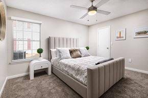 Robinsonville apartment for rent - A bedroom with a large bed and a ceiling fan.