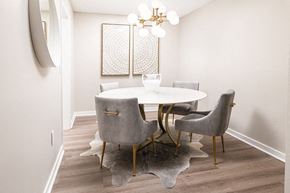 Robinsonville apartment for rent - A dining room with a white table and grey chairs.
