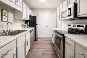 Robinsonville apartment for rent - A kitchen with white cabinets and a black refrigerator.
