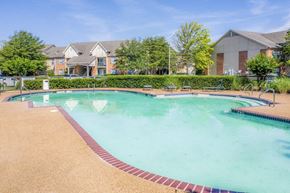 Robinsonville apartment for rent - A large swimming pool surrounded by a brick border and a sandy beach.