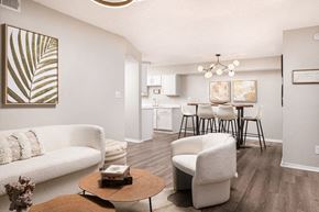 Robinsonville apartment for rent - A living room with a white couch, a coffee table, and a dining area in the background.