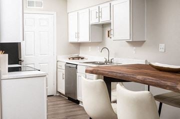 Robinsonville apartment for rent - A kitchen with white cabinets and a wooden island.