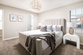 Walls apartment for rent - a bedroom with a large bed and a chandelier