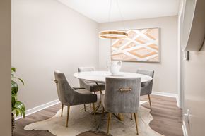 Walls apartment for rent - a dining room with a table and chairs and a painting on the wall