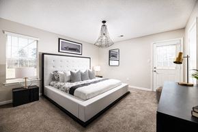 Horn Lake triplex for rent - a bedroom with a bed and a chandelier
