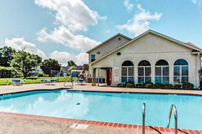 Horn Lake triplex for rent - a large swimming pool in front of a house