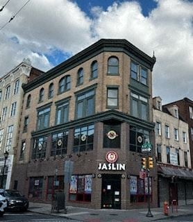 Philadelphia apartment for rent - a tall brick building on the corner of a city street