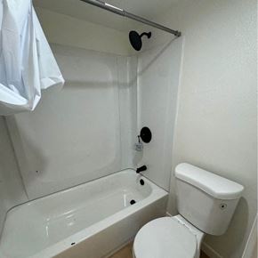 Phoenix apartment for rent - a white bathroom with a toilet and a bath tub