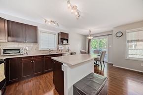 Edmonton house for rent - a kitchen with an island and a dining room with a table